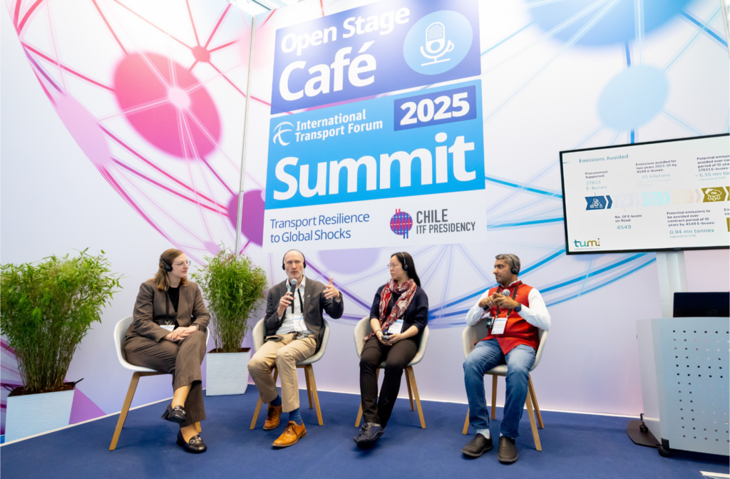 Two women and two men sitting on a stage with blue carpet and the logo of the International Transport Forum Summit 2025 in the background.